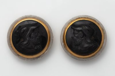 pair of black and gold cameos of a woman and a man
