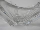 a clear glass bowl that is on a table