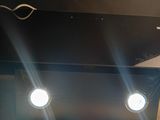 three lights that are on the ceiling above a table