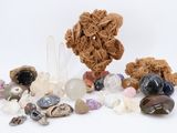 many different types of rocks and stones on a white surface