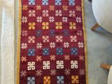 a rug that is on the floor next to a chair