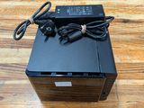 a close up of a small black box on a wooden table