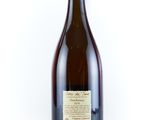 a bottle of wine sitting on top of a white table