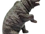 a statue of a bear that is sitting on its hind legs