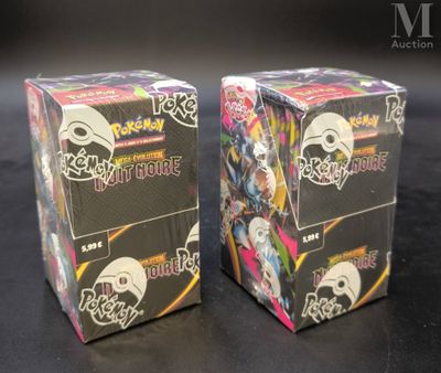 two boxes of pokemon trading cards sitting on a table