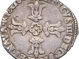 an old silver coin with a cross on it