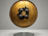 an image of a gold and black bowl on a stand