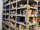 many shelves with boxes and packages on them in a warehouse