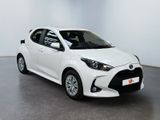 a white toyota yaris parked in a white room