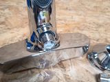 a close up of a faucet and wrenches on a counter