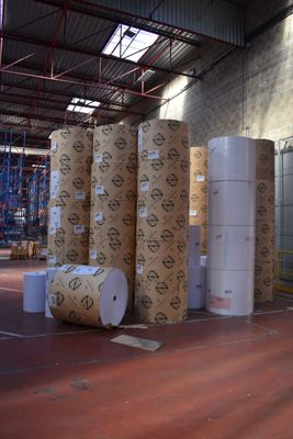 many rolls of paper sitting in a warehouse area