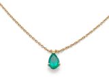 a gold necklace with a tear shaped emerald stone on a chain