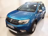 La Dacia bleue est garée dans une pièce blanche au sol blanc.