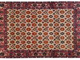 a red and black rug with a medallion design on it