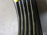 several black and yellow hoses are stacked on top of each other