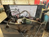 a metal box with tools in it sitting on the floor