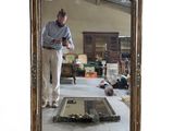 a man that is standing in front of a mirror