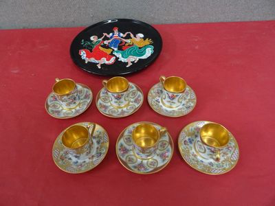 six cups and saucers are sitting on a red table cloth