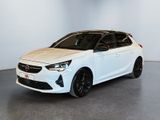 a white car parked in a room with a white wall