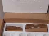 a cardboard box with four cups and a spoon in it