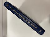 an image of a blue book sitting on top of a white shelf