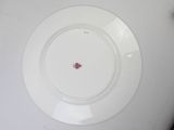 a white plate with a red flower on it