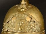 a gold bell with a crown on top of it