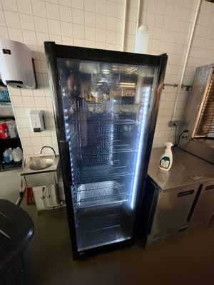 an image of a commercial kitchen with a refrigerator