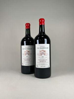 two bottles of wine sitting next to each other on a table