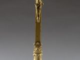 an antique brass crucif with a cross on top of it