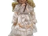 an image of a doll with a white dress and a hat