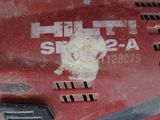 a close up of a red tool with a hole in it