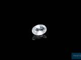 a white diamond on a black surface with a black background