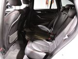 the back seats of a car are black and grey with red trims