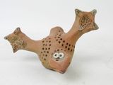 a small ceramic fish that is sitting on a white surface