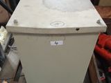 a white refrigerator sitting on a pallet in a warehouse