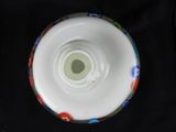 a close up of a white bowl with flowers on it