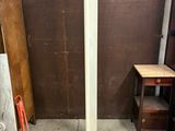 a picture of a floor lamp in a room with a brown wall