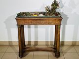 a small table with a plant on top of it