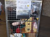 a cart with stuffed animals in it in a warehouse