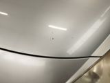 a close up of a white refrigerator with a black handle