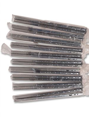 a lot of screws that are on a white surface