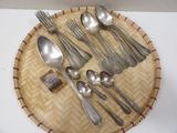 a plate with silverware on it and a spoon and spoon rest on the plate