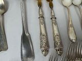 a lot of spoons and forks that are on the table