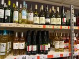 many bottles of wine on the shelves in the store