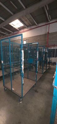 many cages in the warehouse that are empty of people