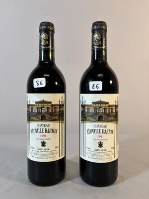 deux bouteilles de vin posées sur une table l'une à côté de l'autre