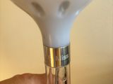 a hand holding a light that is on a table