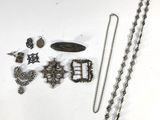 a lot of jewelry on a white surface