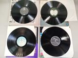three black vinyl records sitting on top of each other on top of a table